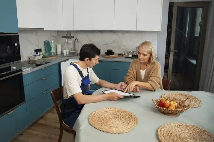 Right kitchen remodeling contractor discussing renovation plans with a homeowner
