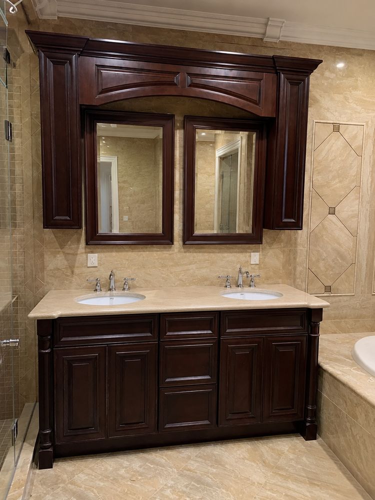 Custom cherry double vanity with marble top and polished chrome fixtures in a Mt. Washington master bathroom